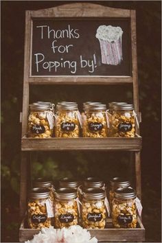 there is a sign that says thanks for popping by and some jars filled with popcorn