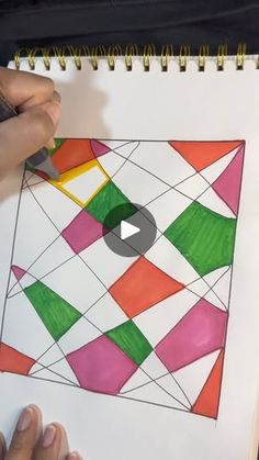 someone is working on an art project with colored paper and crayon pencils