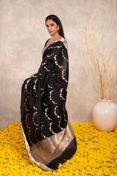 Expertly crafted with pure Katan silk, this black Banarasi saree features intricate Kaduwa sona rupa motifs. The traditional design and luxurious fabric make it a versatile addition to any wardrobe. Elevate your style with this exquisite and timeless piece. Black Cotton Silk Pre-draped Saree For Diwali, Black Art Silk Pre-draped Saree With Zari Weaving, Festive Black Pre-draped Saree With Cutdana, Designer Black Banarasi Silk Saree, Traditional Black Pre-draped Saree, Black Silk Pre-draped Saree For Eid, Black Cotton Silk Pre-draped Saree With Zari Work, Black Pre-draped Saree With Pallu For Festive Occasions, Black Pre-draped Saree With Resham Embroidery