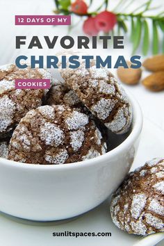 a white bowl filled with cookies covered in powdered sugar on top of a table