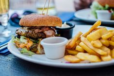 a hamburger and french fries on a white plate