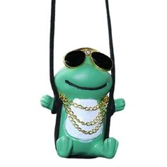 a green frog with sunglasses on it's head hanging from a black cord and wearing a gold chain around its neck