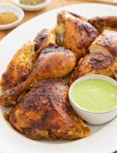 a plate with chicken wings and dipping sauce on it