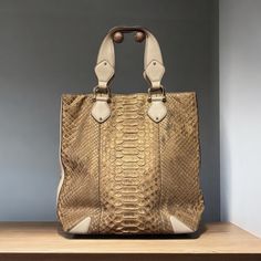 This Gucci Tote Bag Is Crafted From Python With Stunning Craftsmanship. This Iconic Bag Is Light Toned (Tan) With Classic Gold Toned Hardware Including A Magnetic Snap Closure. Almost Zero Wear On This Bag With Only A Few Scales Slightly Lifting. - Size: 14"W X 14"H (Approximate) - Beautiful, Tan Canvas Lining - Made In Italy - Two Interior Pockets, One With Zipper Closure - Authentic Gucci Gucci Gold Tote Shoulder Bag, Gold Gucci Tote Bag, Gucci Formal Hobo Bag With Gold-tone Hardware, Gucci Business Bag With Gold-tone Hardware, Gucci Tote Shoulder Bag With Gold-tone Hardware, Gucci Bags, Gucci Tote Bag, Iconic Bags, Classic Gold