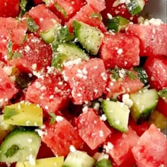 watermelon, cucumber and feta salad in a bowl with sprinkles on top