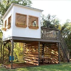 a tree house built into the side of a wooden building with stairs leading up to it