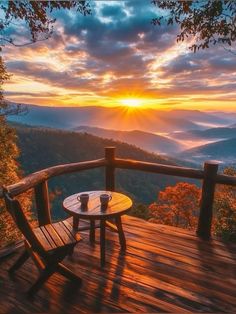 two wooden chairs sitting on top of a wooden deck next to a table under a sunset