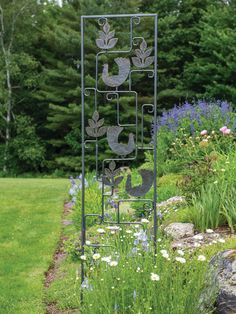 a metal garden decoration with birds and flowers