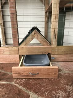 a wooden box with a dog dish in it