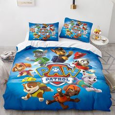 a bed with paw patrol comforter and pillows