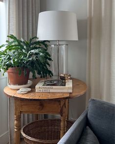 a table with a lamp and some books on it