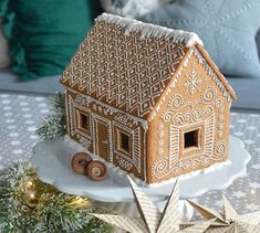 a gingerbread house is sitting on a plate