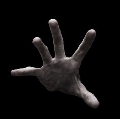 a person's hand reaching up into the air, with their fingers extended out