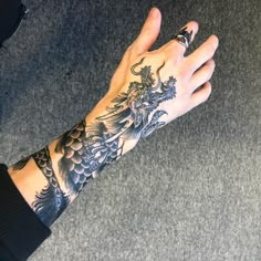 a person's arm with a dragon tattoo on it