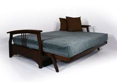 a bed that is made up with a wooden frame