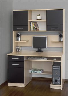 a computer desk with a monitor and keyboard