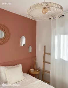 a bedroom with pink walls and white bedding