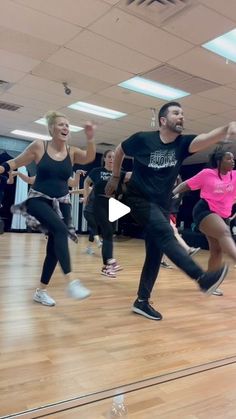 a group of people are dancing on a wooden floor