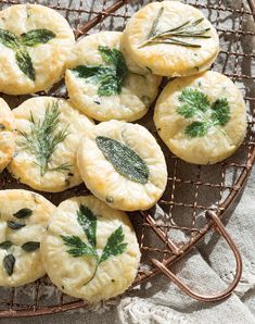 small pastries on a wire cooling rack with herbs and rosemary garnishes