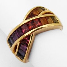 Vintage 18 K (.750) yellow gold crossover design band ring, decorated with multi-gemstones, creating a rainbow look - Peridot, Citrine, Garnet, Amethyst and Topaz. This amazing colorful ring is a size 7, 11.8 mm wide and weighs 8.4 grams. EA1407 Luxury Multicolor Amethyst Ring For Anniversary, Multicolor Gemstone Baguette Cut Rings, Multicolor Gemstone Rings With Baguette Cut, Multicolor Baguette Cut Fine Jewelry Rings, Multicolor Baguette Cut Gemstone Rings, Multicolor Luxury Amethyst Ring For Formal Occasions, Luxury Multicolor Amethyst Ring For Formal Occasions, Multicolor Multi-stone Baguette Cut Rings, Colorful Ring