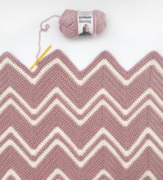 a crochet afghan with yarn next to it