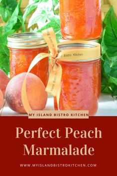 jars filled with peach marmalade sitting on top of a table next to fruit