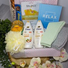 a basket filled with personal care items on top of a wooden table next to flowers