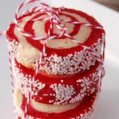 red and white candy canes stacked on top of each other with sprinkles