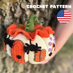 a crochet pumpkin is held in someone's hand with an american flag on it