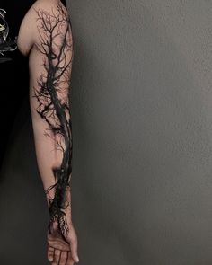 a person with a tree tattoo on their arm