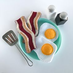 two fried eggs are on a plate next to a fork