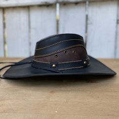 The price INCLUDES sales taxes and SHIPPING costs within the United States
This authentic leather hat, with its distinctive design and a star on the hat band, is a must-have accessory for a unique style. With a 3" brim and 4" crown, this black hat includes an adjustable drawstring for the perfect fit. Made 100% in Mexico, it is ideal for those looking for a quality leather hat with a touch of distinctive character.
Description of the Hat:
Because this hat is made of 100% genuine leather, the col Vintage Leather Hat For Western-themed Events, Vintage Leather Fedora For Rodeo, Adjustable Vintage Leather Hat, Luxury High Crown Adjustable Hat Bands, Adjustable Leather Fedora With Short Brim, Leather Wide Brim Hat With Leather Sweatband, Adjustable Hat With Leather Lining And Curved Brim, Adjustable Leather Fedora, Adjustable Curved Brim Hat With Leather Lining