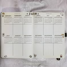 a planner is open to show the calendar on it's side, with stickers