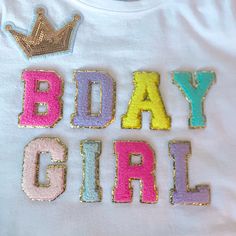 a white shirt with the words body girl painted on it and a crown in the middle