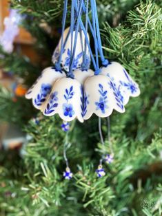 blue and white ornaments hanging from a christmas tree