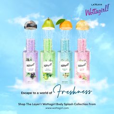 four bottles of freshness on a blue sky with clouds and fruit in the background