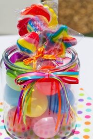 a jar filled with candy sitting on top of a table