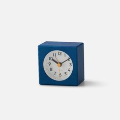 a small blue cube clock on a white background