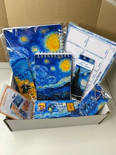 a box filled with assorted items like notebooks and pens