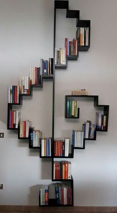 a bookshelf made out of black shelves filled with books