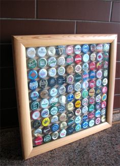 a wooden frame filled with lots of different types of beer bottle caps