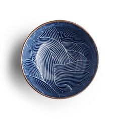 a blue and white bowl with waves on it