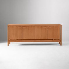 the sideboard is made from wood and has three doors