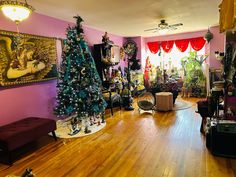 a living room filled with furniture and christmas trees