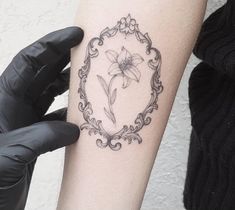 a woman's arm with a tattoo on it and a flower in the middle