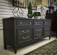 a black dresser sitting on top of a carpeted floor