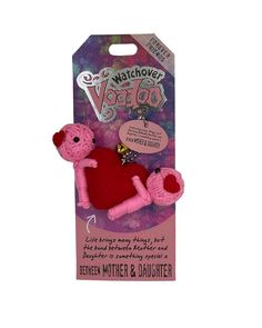 a pink teddy bear with a red heart on it's back in a package