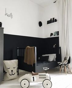 a child's bedroom with black and white decor