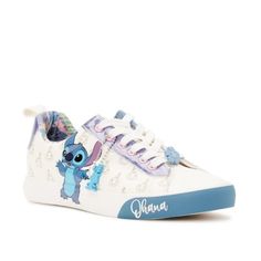 These Cute Sneakers Include Fan Favorite, Stitch, Blue Glitter And A Tropical Inner Print To Add A Pop Of Color To Your Outfit. Includes A Removable Keychain With The Silhouette Of Lilo's Doll Scrump To Match The Allover Scrump Print On The Sides. Bonus: An Adorable Hibiscus Flower Lace Charm Sits At The Front For Extra Flair. Shoe Closure: Lace-Up Materials: Manmade Upper End Use: Casual Silhouette For Everyday Wear Clean & Care: Wipe Clean With Damp Cloth Features: Fun Prints; Blue Glitter Det Cute Low-top Sneakers With Vulcanized Sole, Casual White Sneakers With Character Print, Synthetic Sneakers With Character Print And Round Toe, Cute Low-top Synthetic Sneakers, Cute Slip-on Synthetic Sneakers, Cute Synthetic Slip-on Sneakers, Casual Low-top Sneakers With Character Print, Disney Low-top Sneakers With Rubber Sole, Cute Lace-up Sneakers With Speckled Midsole