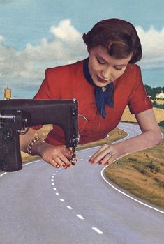 a woman is holding a sewing machine on the road